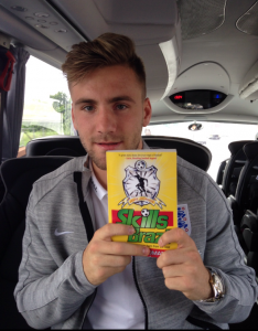 Manchester United left-back Luke Shaw with his copy of "Skills from Brazil"
